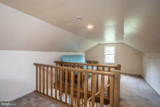 additional living space with carpet flooring and vaulted ceiling