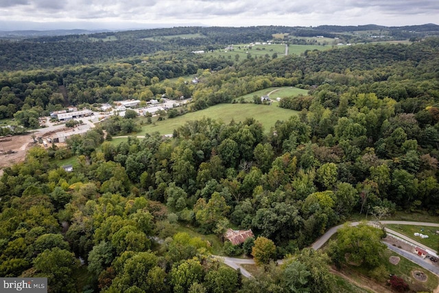 drone / aerial view featuring a wooded view