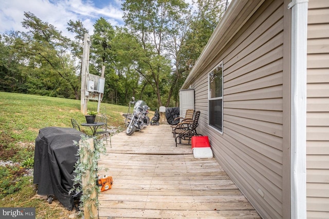 wooden deck featuring a yard and area for grilling