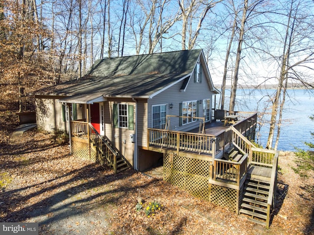 back of property with a deck with water view