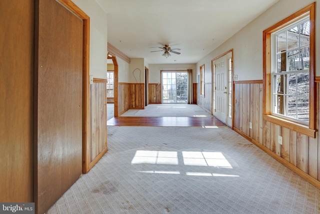 corridor with wood walls and light colored carpet