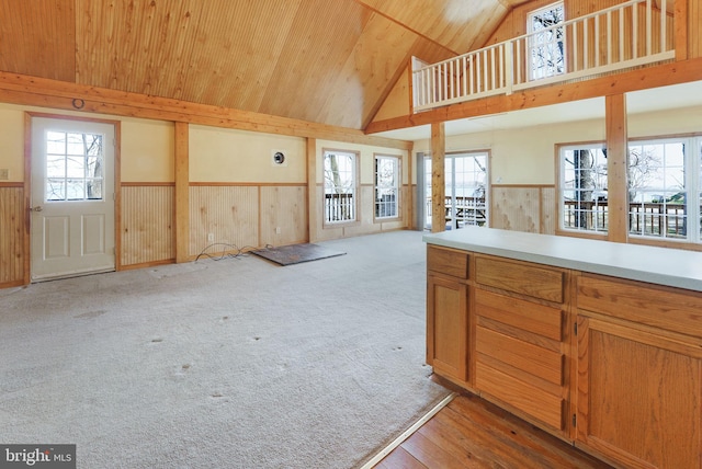 kitchen with wood ceiling, wood walls, light hardwood / wood-style flooring, and high vaulted ceiling