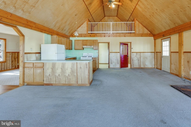 kitchen with high vaulted ceiling, white appliances, ceiling fan, wooden walls, and light carpet