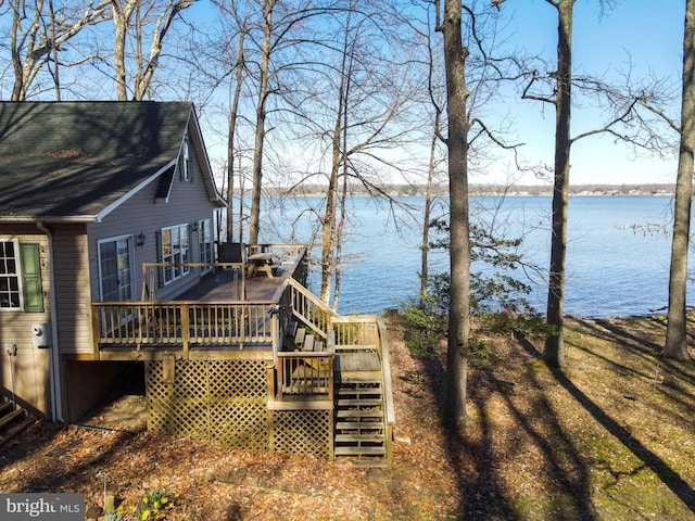 exterior space with a deck with water view