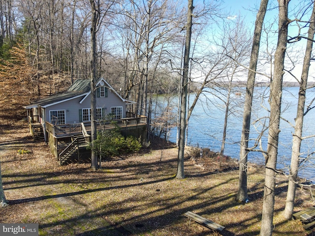 exterior space with a deck with water view