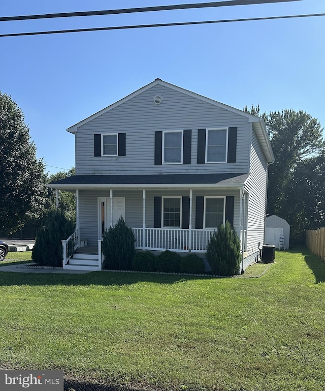 front of property featuring a porch, a front lawn, and central air condition unit