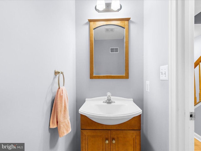 bathroom featuring hardwood / wood-style flooring and vanity