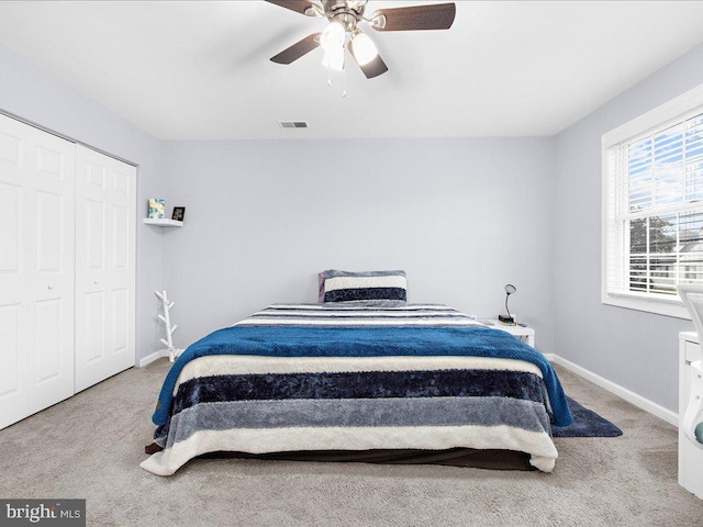 bedroom with ceiling fan, carpet floors, and a closet