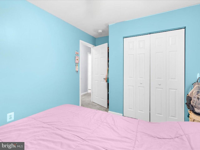 carpeted bedroom with a closet