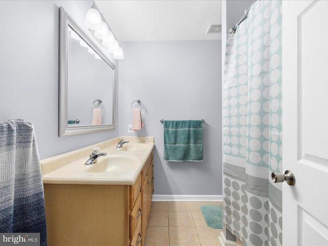 bathroom featuring walk in shower, vanity, and tile patterned floors