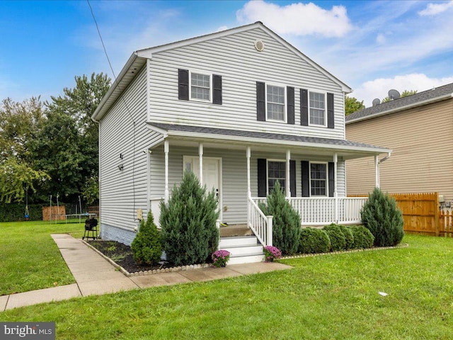 front of property featuring a front lawn and covered porch