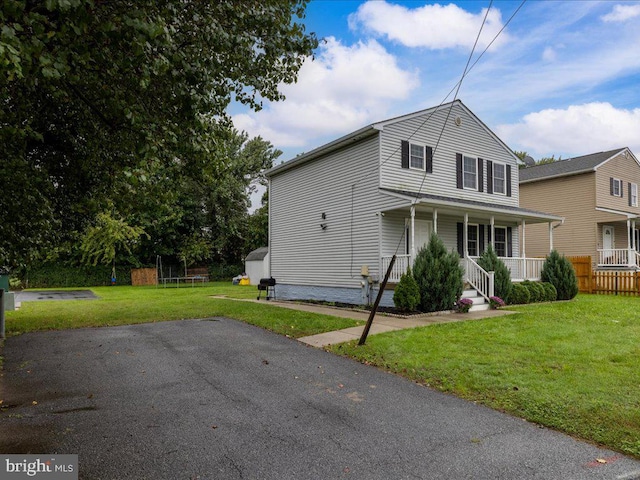 view of front of home featuring a front yard and a porch