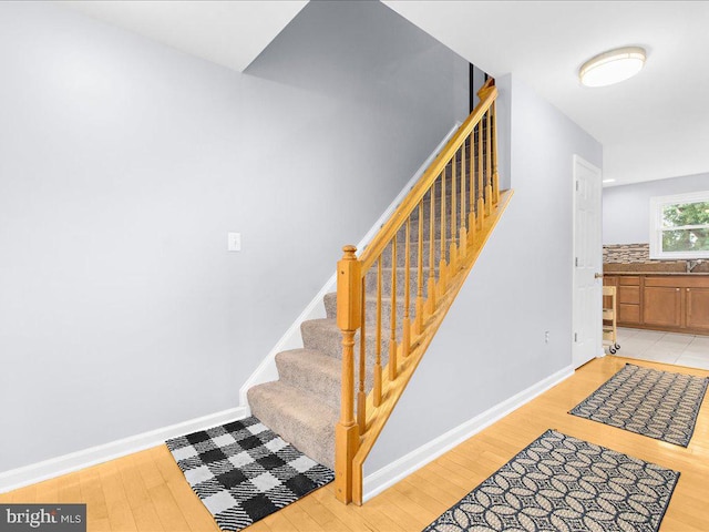 stairs with hardwood / wood-style flooring