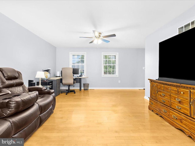 living room featuring ceiling fan and light hardwood / wood-style flooring