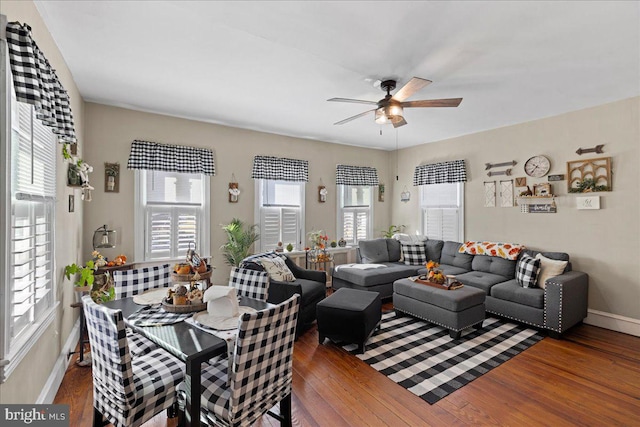 living room with ceiling fan, dark wood-type flooring, and a wealth of natural light