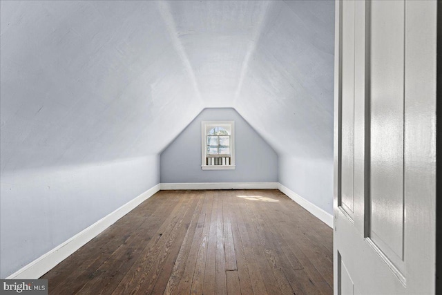 bonus room featuring lofted ceiling and dark hardwood / wood-style floors