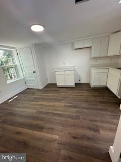 clothes washing area with dark hardwood / wood-style flooring