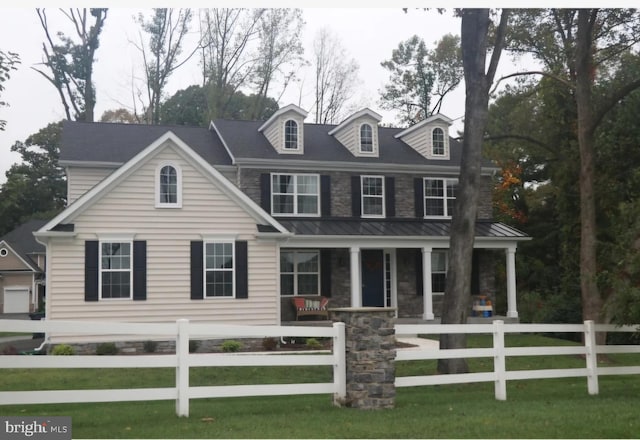 view of front of house with a front yard and a porch