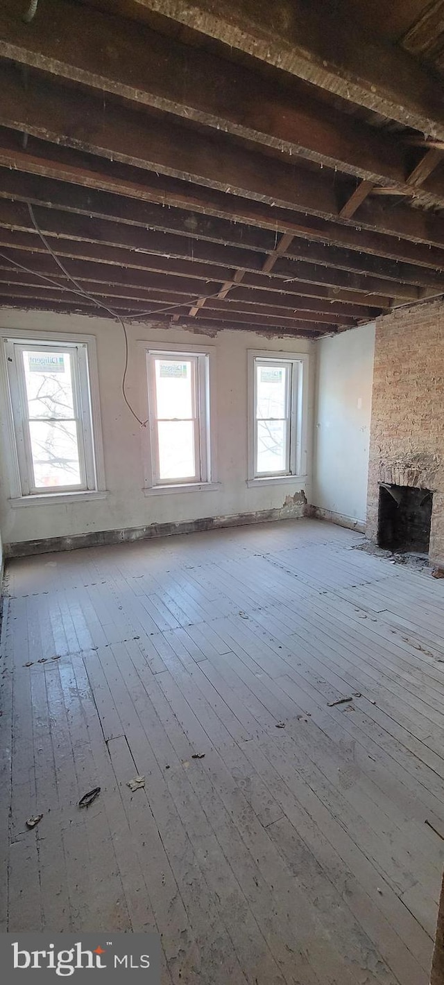 misc room featuring hardwood / wood-style flooring and beam ceiling