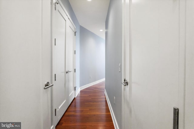 corridor with dark hardwood / wood-style flooring