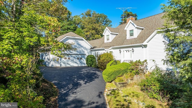 11160 Cove Lake Rd, Lusby, MD 20657 - view of front of home with a garage, roof with shingles, and a chimney