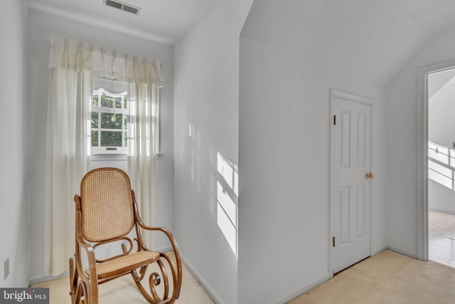 hall with light colored carpet and lofted ceiling