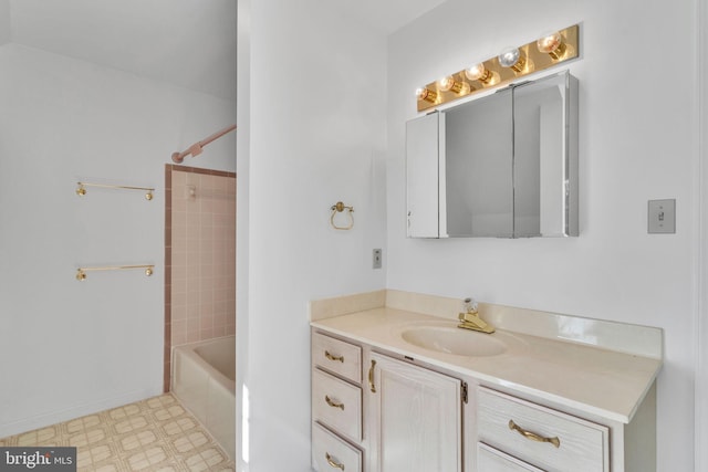 bathroom with tiled shower / bath and vanity