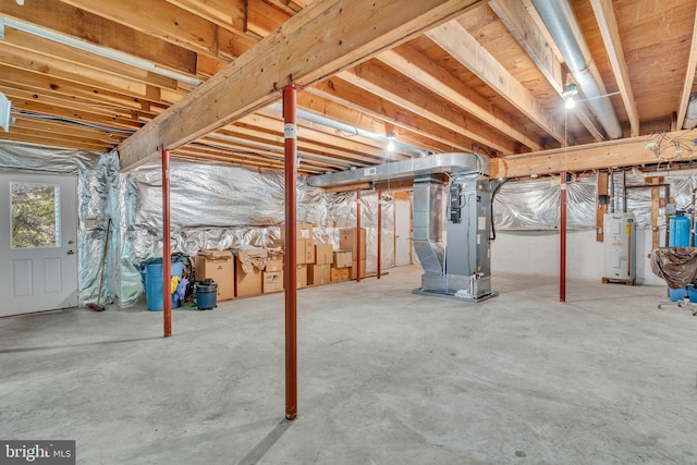 basement featuring heating unit and water heater