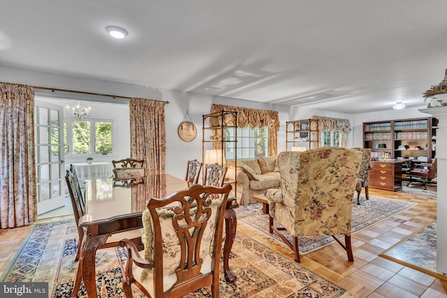 dining space with an inviting chandelier and light parquet floors