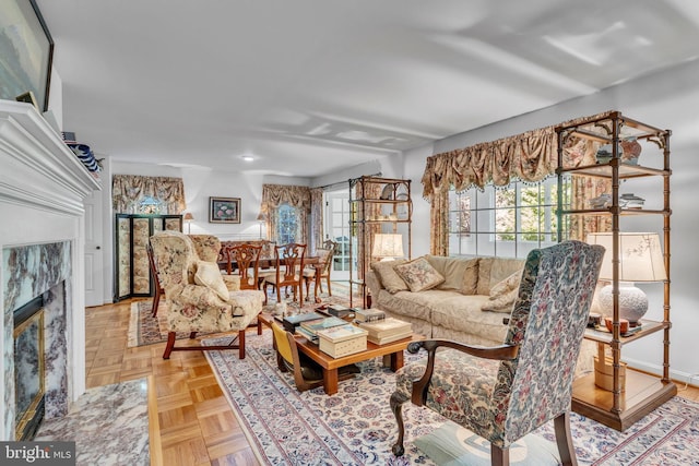 living room with a fireplace and light parquet flooring