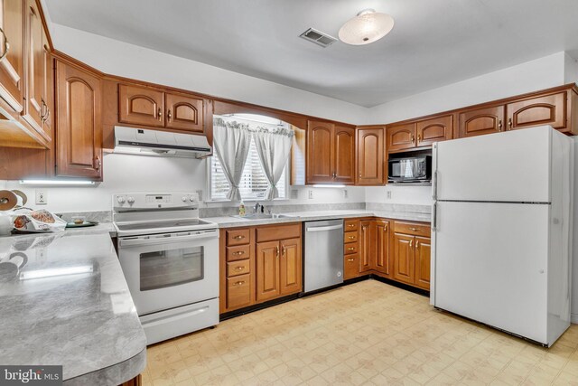 11160 Cove Lake Rd, Lusby, MD 20657 - kitchen with visible vents, a sink, light countertops, white appliances, and under cabinet range hood