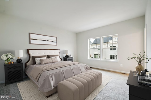 bedroom featuring light colored carpet