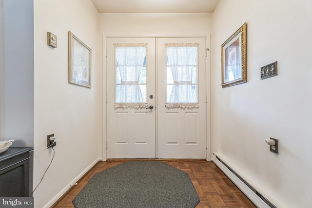 doorway to outside featuring french doors, baseboard heating, and dark parquet floors