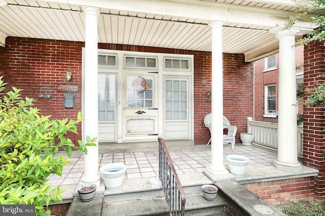 view of exterior entry featuring a porch