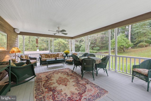 sunroom featuring ceiling fan