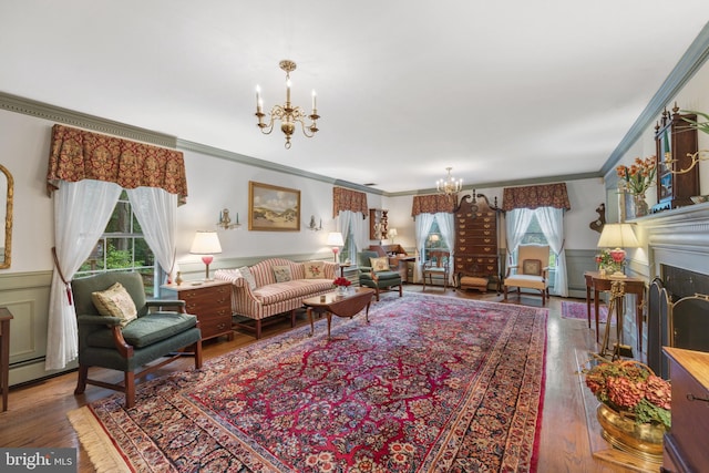 living room featuring a healthy amount of sunlight, crown molding, and hardwood / wood-style floors