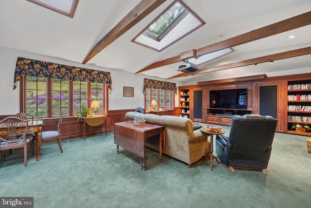 living room with lofted ceiling with skylight, wood walls, and carpet