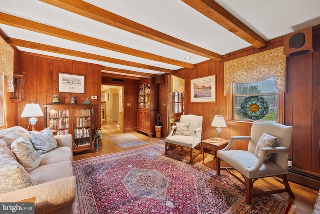 living room featuring wood walls, hardwood / wood-style floors, and beam ceiling