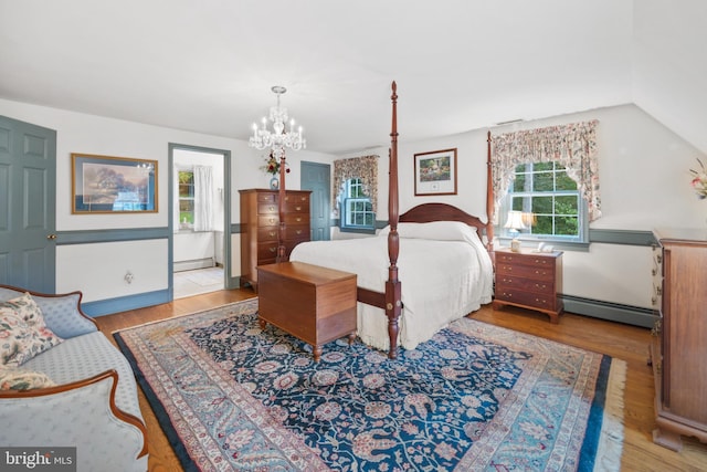 bedroom with light wood-type flooring, multiple windows, and a baseboard heating unit