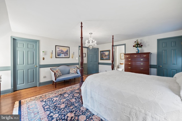 bedroom featuring a notable chandelier and hardwood / wood-style floors