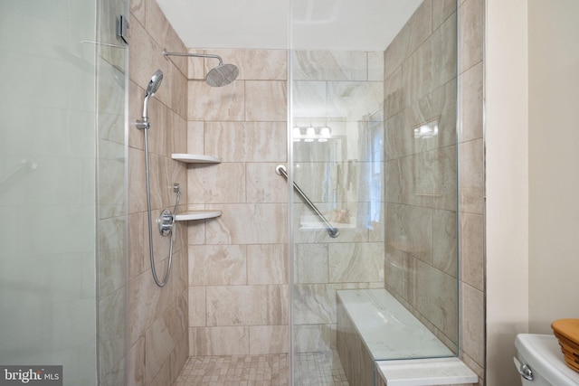 bathroom with tiled shower and toilet