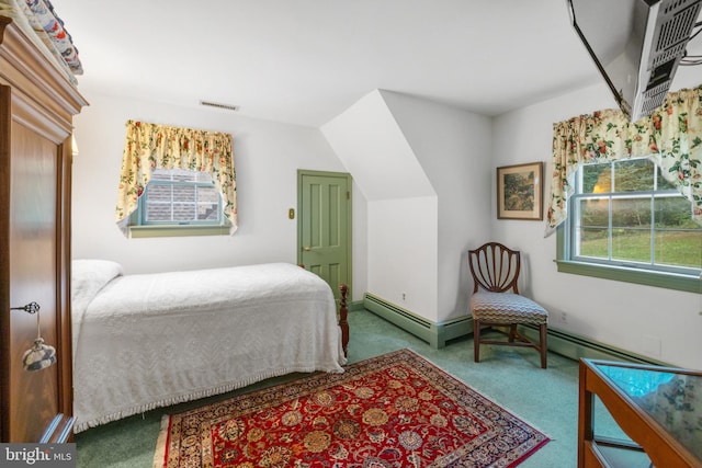 bedroom with carpet floors, lofted ceiling, and a baseboard heating unit