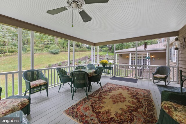 sunroom / solarium featuring ceiling fan