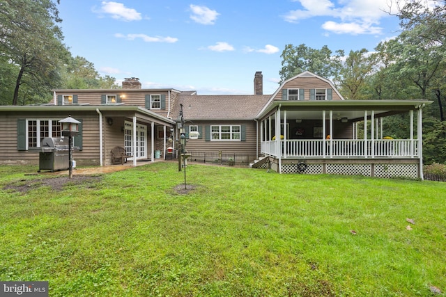 back of house with a lawn