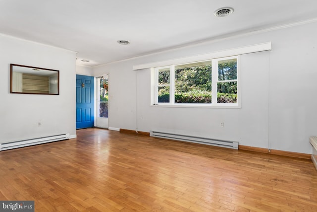 empty room with crown molding, a baseboard radiator, and light wood-type flooring