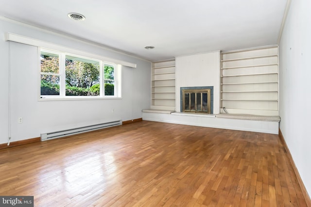 unfurnished living room featuring ornamental molding, hardwood / wood-style floors, and baseboard heating