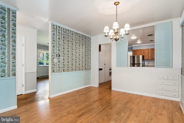 unfurnished room with ornamental molding, light hardwood / wood-style flooring, an inviting chandelier, and a baseboard heating unit