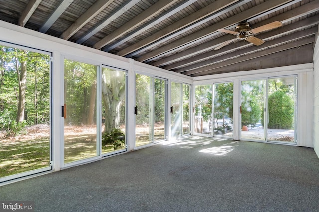 unfurnished sunroom with vaulted ceiling with beams and ceiling fan