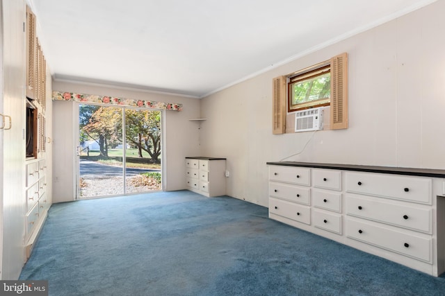 spare room with a healthy amount of sunlight, ornamental molding, and light colored carpet