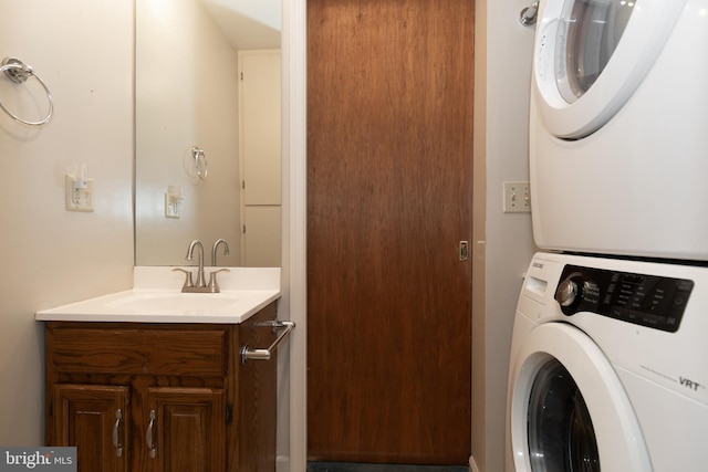 clothes washing area with sink and stacked washer and dryer